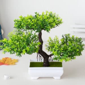 Plante artificielle bonsaï en plastique vert en pot blanc.