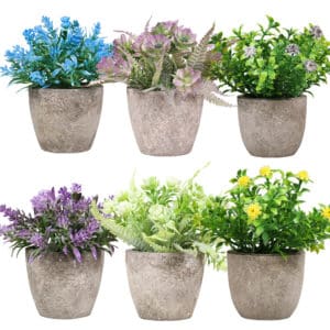 6 plantes artificielles de couleurs différentes dans un pot gris
